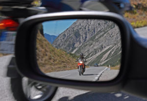 Motorcyclist in a rearview mirror.