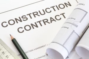 A construction contract and pencil. 