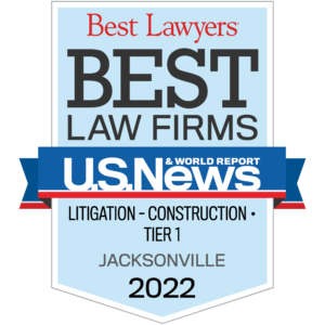 Award badge from U.S. News & World Report featuring "Best Law Firm Jacksonville Construction – Litigation" text, listing specialties in litigation and construction for Jacksonville, Tier 1, 2022.